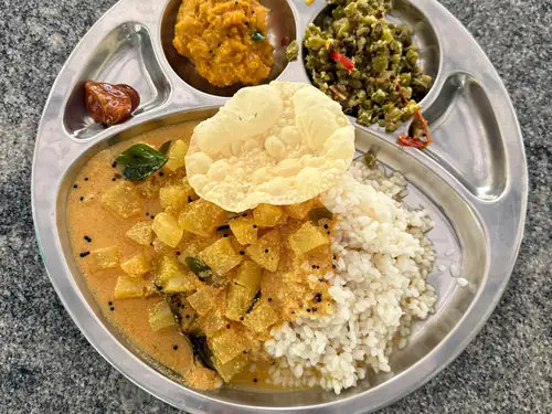 A simple Attappadi-style vegetarian meal served on a steel plate